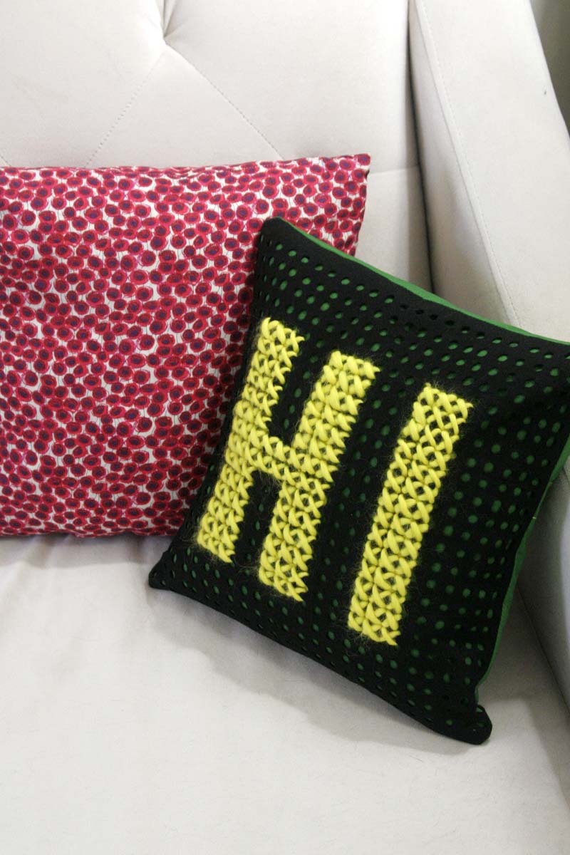 cross stitch pillow on couch